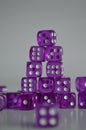 Pile of multiple purple plastic arcylic d6 six sided die dice variable focus Royalty Free Stock Photo