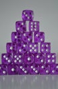 Pile of multiple purple plastic arcylic d6 six sided die dice variable focus Royalty Free Stock Photo