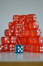 Pile of multiple red plastic arcylic d6 six sided die dice variable focus Royalty Free Stock Photo