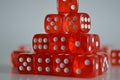 Pile of multiple red plastic arcylic d6 six sided die dice variable focus Royalty Free Stock Photo