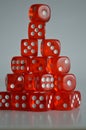 Pile of multiple red plastic arcylic d6 six sided die dice variable focus Royalty Free Stock Photo