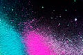 Pile of natural colored pigment powder. Green pink white powder particles splatter on black blackground Royalty Free Stock Photo