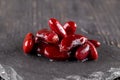 Pile of natural cooked red beans on a black board on the dark wooden background