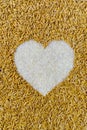 Pile of natural rice grains in heart shape Royalty Free Stock Photo