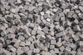 Pile of natural stone cubes for making outdoor pavement tiles.