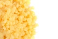 Pile of Natural Yellow Beeswax Pearls on a Wax Background