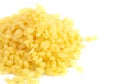 Pile of Natural Yellow Beeswax Pearls on a Wax Background