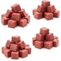 A pile of neatly cut raw beef cubes is arranged in a pyramid shape on white background. Royalty Free Stock Photo