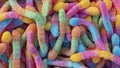 Pile of neon sugary gummy worms or  chewy sour crawlers background Royalty Free Stock Photo