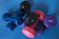 A pile of neoprene coated iron dumbbells of different weights