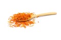 A pile of New Dried Safflower petals herb Tea on a wooden spoon.  on a white background Royalty Free Stock Photo