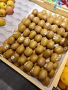 Pile of New Zealand Zespri gold kiwifruit in the fruit section of the supermarket
