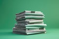 Pile of newspapers on green background. Business concept. Copy space, Stack of newspapers on green background with copy space.