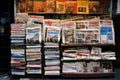 A pile of newspapers stacked on top of each other, ready to provide a wealth of information and news., Newspapers are arranged on