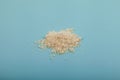 Pile of Nisin powder on blue surface, selective focus. Food additive E234, extremely effective against yeast and fungi even at