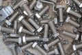 pile of nut and bolts on a dirty floor