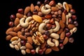 A pile of nuts on a black background. Ideal for food and nutrition-related projects Royalty Free Stock Photo