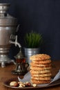 Pile Oatmeal Cookies with nuts and black tea at Samovar on a wooden table Royalty Free Stock Photo