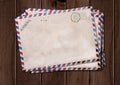 Old air mail envelopes on wooden table Royalty Free Stock Photo