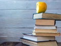 Pile of old books and bitten apple Royalty Free Stock Photo