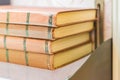 Pile of old books with brown retro cover on shelf. Selective focus Royalty Free Stock Photo