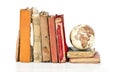 Pile of old books with old globe isolated Royalty Free Stock Photo