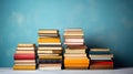 Pile of old books on wooden table with blue wall background Royalty Free Stock Photo