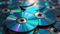A pile of old CDs and DVDs with rainbow reflections. These optical discs are a symbol of outdated digital data storage and Royalty Free Stock Photo