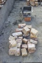 Pile of old clay bricks and cement mortar trowel for building