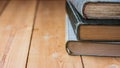 Pile of old closed books on aged wood backgound, negative space for text Royalty Free Stock Photo