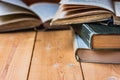 Pile of old closed and open books on aged wood backgound, negative space for text Royalty Free Stock Photo