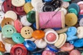 Pile of old colored buttons with thread and needle Royalty Free Stock Photo