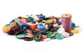 Pile of old colored buttons with thread and needle on white back Royalty Free Stock Photo
