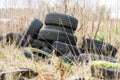 Pile of Old discarded tyres on the grass