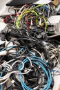 Pile of old electronic devices and cables ready for waste collection or recycling, no people