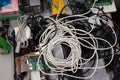 Pile of old electronic devices and cables ready for waste collection or recycling, no people