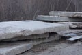 A pile of old gray industrial concrete slabs