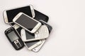 A pile of old mobile phones isolated on white. Place for text.