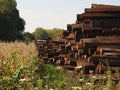 Pile of railway sleepers next to Cornfield