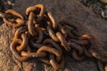 Pile of old rusty mooring chain in sunlight