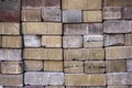 Pile of old shabby red, gray and yellow bricks. rough surface texture Royalty Free Stock Photo