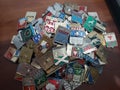 Pile of an old Soviet USSR pins medals badges placed on wooden desk. Flea market. May 30, 2021 Soviet memorabilia