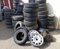 Pile of old tires and wheel rims near the workshop