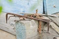 Pile of old tools and pieces of iron lying on the wooden frame of the old house