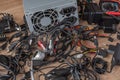 Pile of old wires, connections, headphones and chargers on a wooden table close-up. Replacement of old elements and