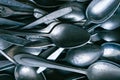 Pile of old worn vintage cutlery. Background of aluminium forks and spoons Royalty Free Stock Photo