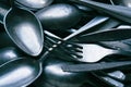 Pile of old worn vintage cutlery. Background of aluminium forks and spoons. Close-up Royalty Free Stock Photo