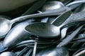 Pile of old worn vintage cutlery. Background of aluminium forks and spoons. Close-up Royalty Free Stock Photo