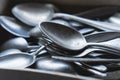 Pile of old worn vintage cutlery. Background of aluminium forks and spoons. Close-up. Side view Royalty Free Stock Photo