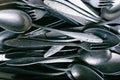Pile of old worn vintage cutlery. Background of aluminium forks and spoons. Top view Royalty Free Stock Photo